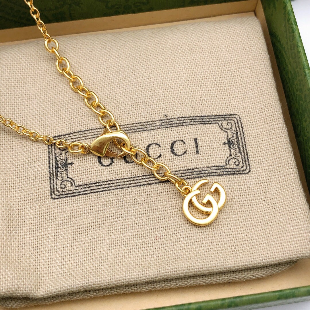 Double-G Emblem Pendant Necklace in Polished Metal-Tone – Crystal Detail – Design 005 close-up detail