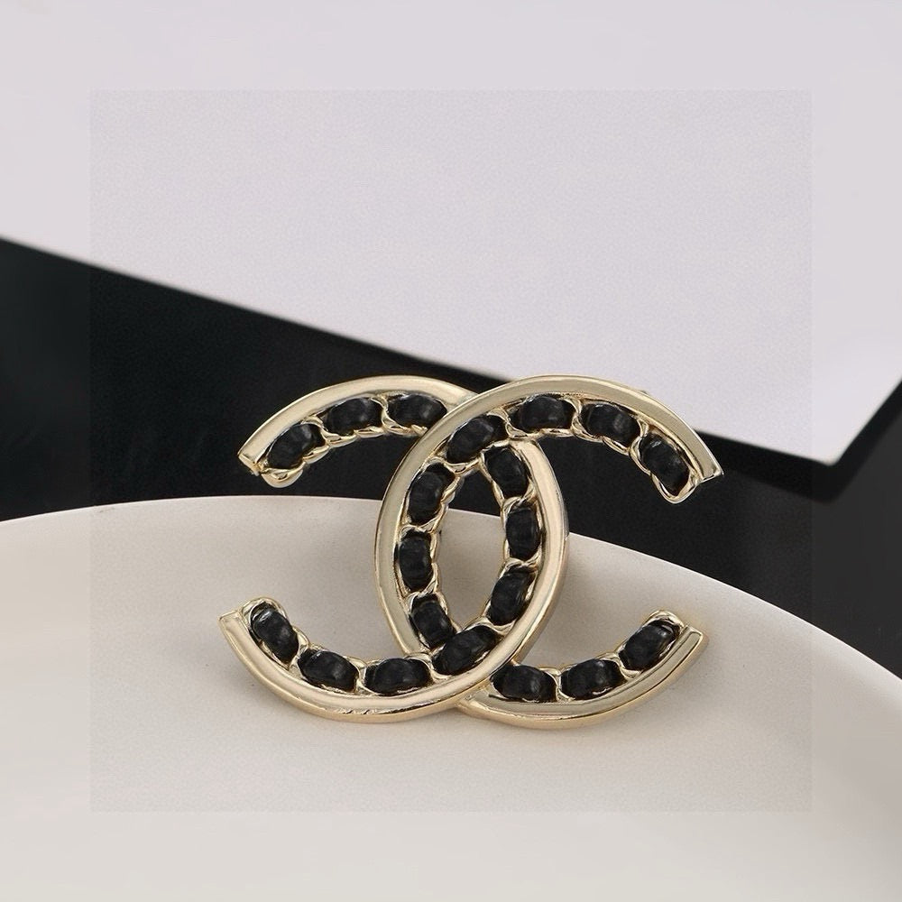 Double-C Emblem Brooch in Polished Metal-Tone – Black Detail front product view