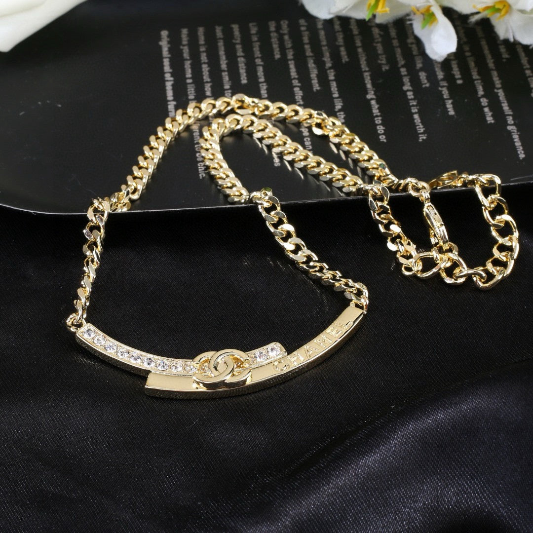 Double-C Emblem Pendant Necklace in Polished Metal-Tone – White Detail detail view