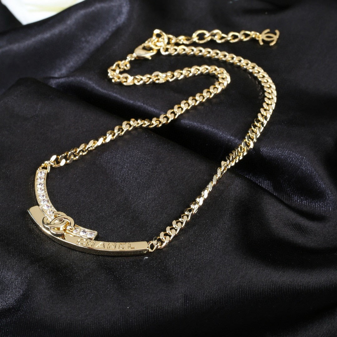 Double-C Emblem Pendant Necklace in Polished Metal-Tone – White Detail styled product view