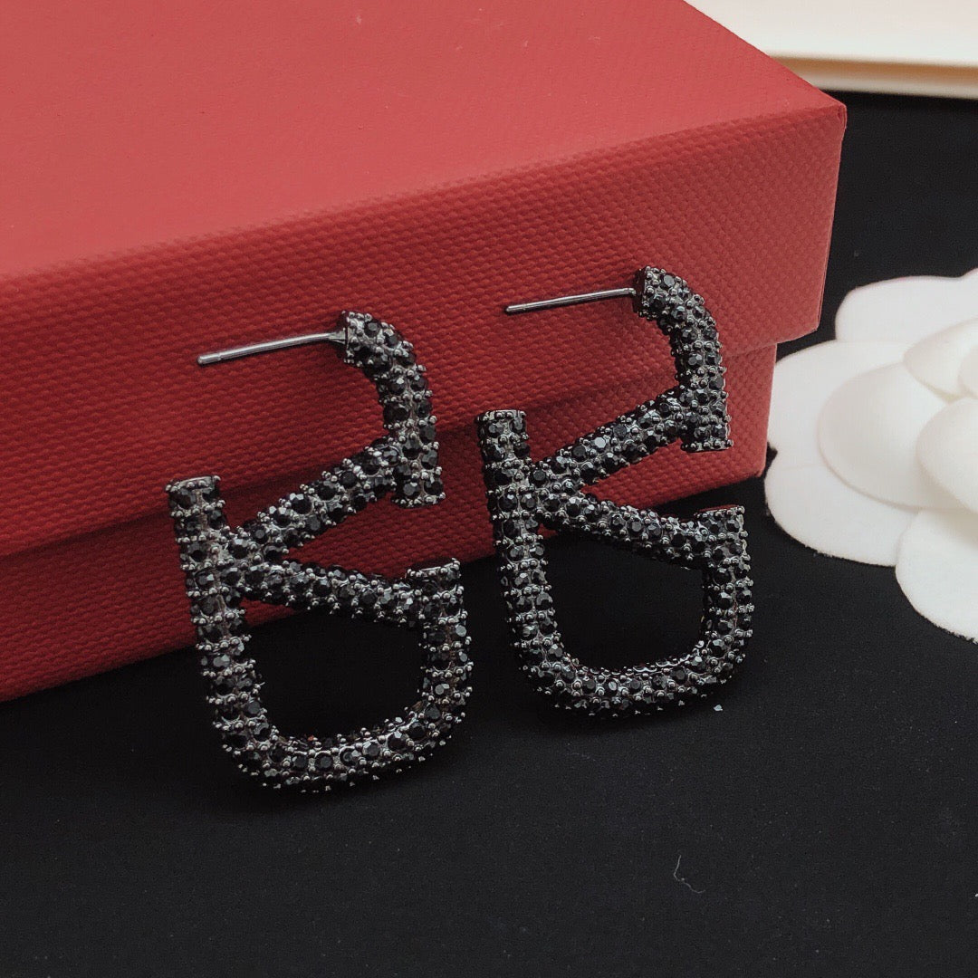 Signature Emblem Crystal-Accent Stud Earrings – Black close-up view