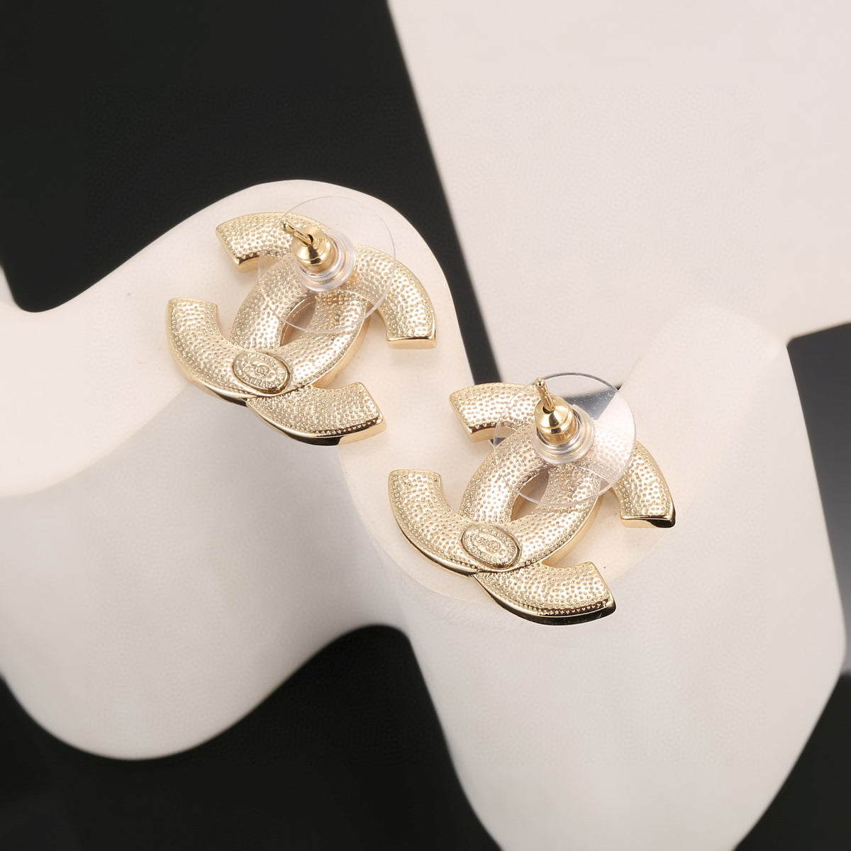 Double-C Emblem Stud Earrings in Polished Metal-Tone – Design 024 close-up detail