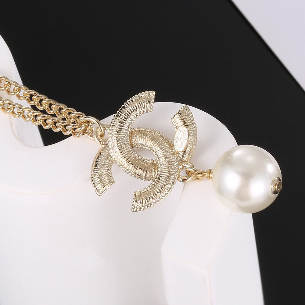 Double-C Emblem Pearl-Detail Pendant Necklace – Pearl Detail – Design 130 styled product view
