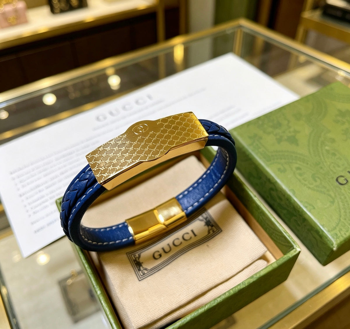 Double-G Emblem Bangle in Polished Metal-Tone – Leather Detail – Design 003 close-up detail