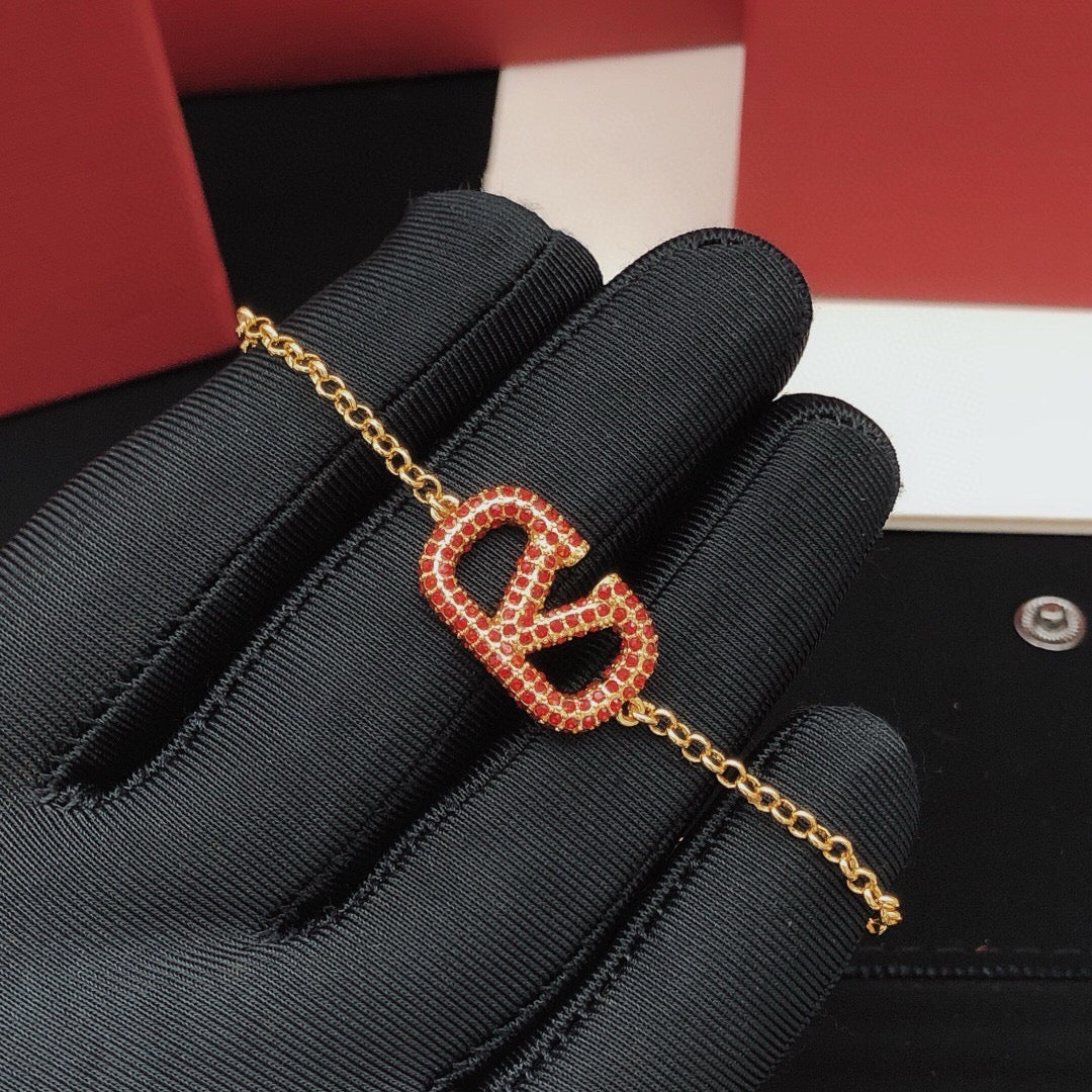 Signature Emblem Jewelry Accessory – Red close-up view