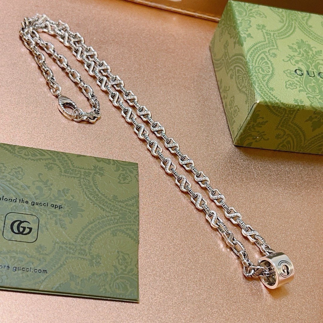 Double-G Emblem Pendant Necklace in Polished Metal-Tone – Vintage Detail – Design 012 close-up detail