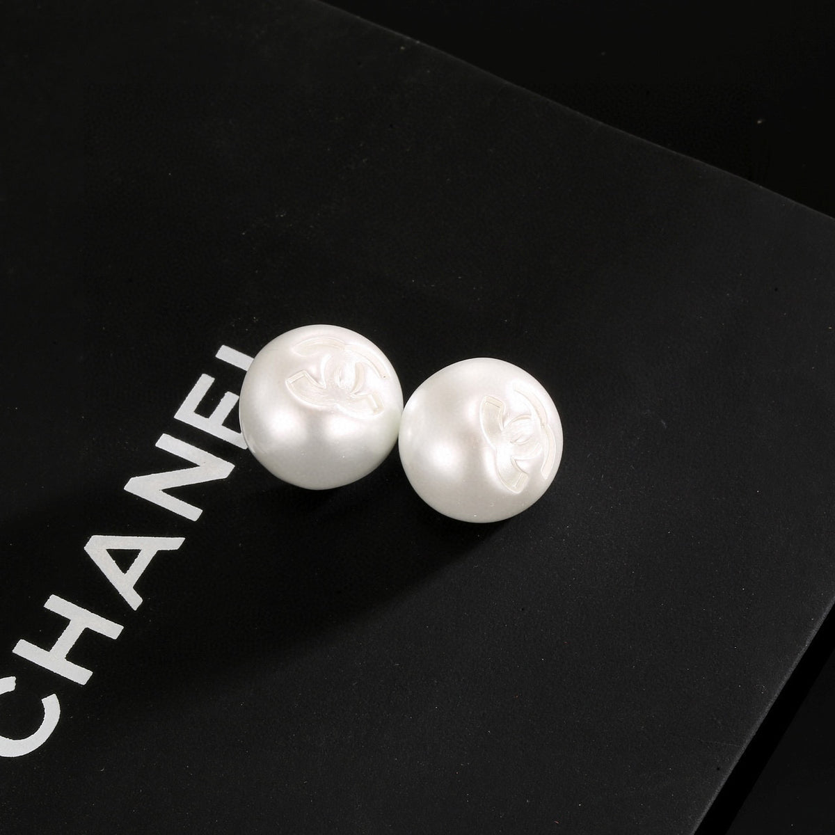 Double-C Emblem Stud Earrings in Polished Metal-Tone – White Detail front product view