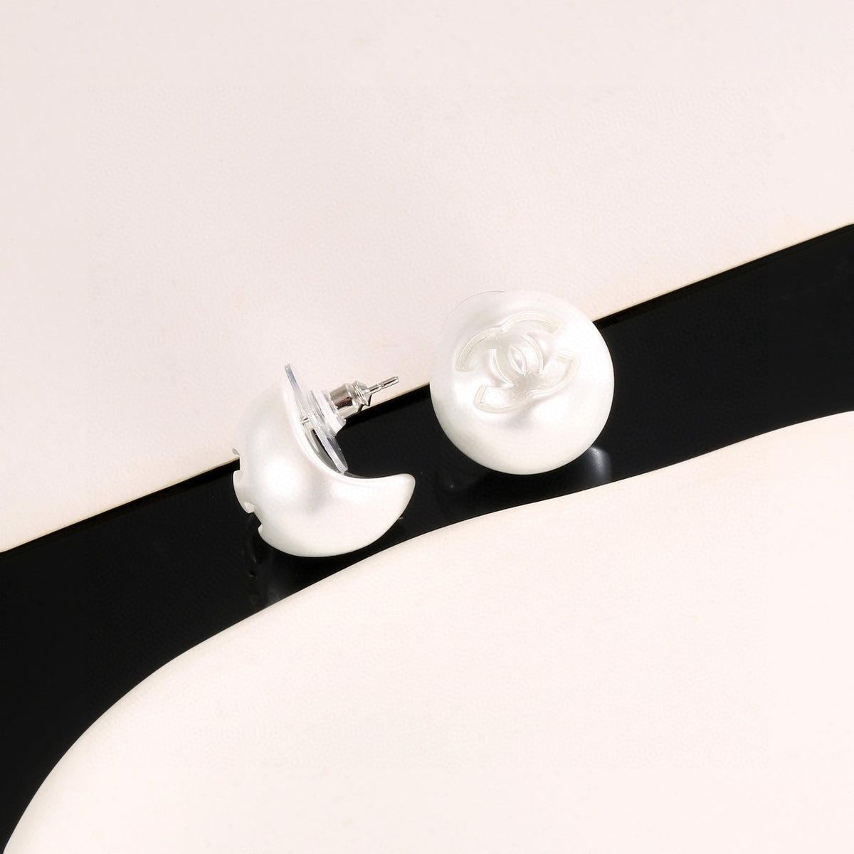 Double-C Emblem Stud Earrings in Polished Metal-Tone – White Detail – Design 002 detail view