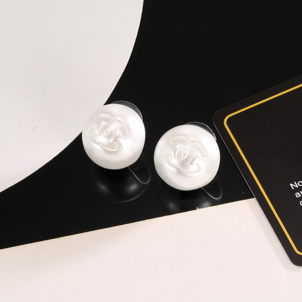 Double-C Emblem Stud Earrings in Polished Metal-Tone – White Detail – Design 002 main product view