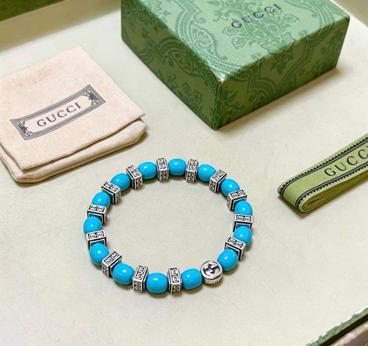 Double-G Emblem Beaded Bracelet in Polished Metal-Tone – Turquoise Detail close-up detail